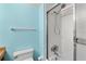 Bathroom with a light blue wall and white shower and tub at 31 Island Way # 106, Clearwater Beach, FL 33767