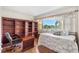 Comfortable bedroom featuring a large window and a built-in bookcase at 31 Island Way # 106, Clearwater Beach, FL 33767