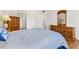 Spacious bedroom with wood-look floors, an armoire, and plenty of closet space at 31 Island Way # 106, Clearwater Beach, FL 33767