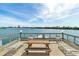 Waterfront deck with lounge chairs, a picnic table, seating, and water views for relaxation and enjoyment at 31 Island Way # 106, Clearwater Beach, FL 33767