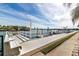 Dock featuring park benches overlooking the water with palm trees at 31 Island Way # 106, Clearwater Beach, FL 33767