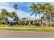 Landscaped exterior with lush greenery, manicured lawn, palm trees, and a circular driveway leading to a welcoming home at 31 Island Way # 106, Clearwater Beach, FL 33767