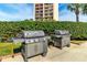 Community grill featuring two gas grills overlooking a high-rise building at 31 Island Way # 106, Clearwater Beach, FL 33767