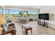 Bright living room featuring large windows offering a beautiful waterfront view at 31 Island Way # 106, Clearwater Beach, FL 33767