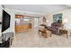 Open living room with tile flooring, a modern TV, and kitchen access at 31 Island Way # 106, Clearwater Beach, FL 33767