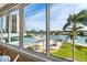 Stunning waterfront views from the property's patio with a pool and palm trees at 31 Island Way # 106, Clearwater Beach, FL 33767