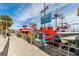 Vibrant waterfront scene with docked boats, restaurant, and a lively atmosphere for a fun time at 31 Island Way # 106, Clearwater Beach, FL 33767