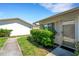 Inviting entryway with a clear glass door, framed by vibrant greenery and leading to a cozy home at 3111 37Th S Ln # A, St Petersburg, FL 33711