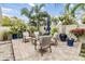 Charming patio with brick pavers, comfortable seating, and lush tropical landscaping creates a private outdoor oasis at 3206 W Lemon St, Tampa, FL 33609