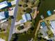 Aerial view showcases a charming home with a metal roof and canals, perfect for waterfront living and relaxation at 3609 Flamingo Blvd, Hernando Beach, FL 34607