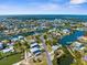 Expansive aerial view of a waterfront community featuring canals, boats, and houses, offering a picturesque coastal lifestyle at 3609 Flamingo Blvd, Hernando Beach, FL 34607