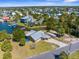 Aerial view of a charming home featuring a metal roof, surrounded by lush greenery in a waterfront community at 3609 Flamingo Blvd, Hernando Beach, FL 34607