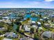 Expansive aerial view of a waterfront community featuring canals, boats, and houses, offering a picturesque coastal lifestyle at 3609 Flamingo Blvd, Hernando Beach, FL 34607
