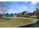 Waterfront backyard featuring a private dock with chairs and scenic waterway views at 3609 Flamingo Blvd, Hernando Beach, FL 34607