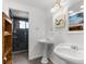 Bathroom featuring tile floors, dual sinks, and shower with glass doors at 3609 Flamingo Blvd, Hernando Beach, FL 34607