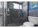 Modern bathroom featuring a walk-in shower with gray tiling and a built-in shower seat at 3609 Flamingo Blvd, Hernando Beach, FL 34607