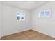 Minimalist bedroom with tile flooring, white walls, and natural light from two windows at 3609 Flamingo Blvd, Hernando Beach, FL 34607
