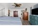 Bedroom with wood floors, ceiling fan, and access to hallway and closet at 3609 Flamingo Blvd, Hernando Beach, FL 34607