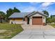 Charming single-story home with stone accents, metal roof, well-manicured lawn, and inviting curb appeal at 3609 Flamingo Blvd, Hernando Beach, FL 34607