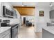 Kitchen area showing stainless steel appliances, wood ceiling, and tile floors at 3609 Flamingo Blvd, Hernando Beach, FL 34607