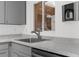 Kitchen area featuring granite counters, stainless steel faucet, and gray cabinets at 3609 Flamingo Blvd, Hernando Beach, FL 34607
