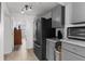 Kitchen area showcasing stainless steel refrigerator, cabinets, and access to other room at 3609 Flamingo Blvd, Hernando Beach, FL 34607