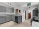 Modern kitchen featuring gray cabinets, stainless steel appliances, and bright natural light at 3609 Flamingo Blvd, Hernando Beach, FL 34607