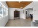 Bright living room with tile floors, a wooden ceiling, and neutral paint at 3609 Flamingo Blvd, Hernando Beach, FL 34607