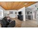 Cozy living room featuring beautiful flooring, a wooden beamed ceiling, and bright natural light at 3609 Flamingo Blvd, Hernando Beach, FL 34607