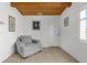 Bright sitting room featuring tile floors, a wooden ceiling, and neutral paint at 3609 Flamingo Blvd, Hernando Beach, FL 34607