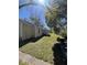 A well-maintained backyard featuring lush green grass and mature trees providing ample shade and curb appeal at 37324 Rose Ave, Dade City, FL 33523