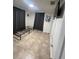 Bedroom featuring tile floors, grey curtains and a tv at 37324 Rose Ave, Dade City, FL 33523