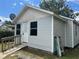 Charming single-story home with white door, gray siding, and well-maintained yard at 37324 Rose Ave, Dade City, FL 33523