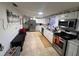 Bright kitchen with stainless steel appliances and white cabinets at 37324 Rose Ave, Dade City, FL 33523