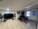 Bright living and dining area with tile floors, television, and outdoor access at 37324 Rose Ave, Dade City, FL 33523