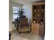 Cozy sitting area with comfortable chair, decorative shelving, and natural light at 37324 Rose Ave, Dade City, FL 33523