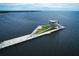 Elevated aerial view of a modern pier extending into the ocean, featuring green spaces and architectural design at 3926 Indianapolis Ne St, St Petersburg, FL 33703