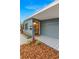 Stylish front entrance featuring a patterned tile walkway, a modern light fixture, and professional landscaping at 3926 Indianapolis Ne St, St Petersburg, FL 33703