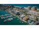 An aerial view showcases a coastal city with boats docked in the harbor against a backdrop of sandy beaches and clear blue waters at 479 E Shore Dr # 8, Clearwater, FL 33767