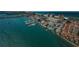 An aerial view shows a coastal city with a marina on the water and condos on the beach at 479 E Shore Dr # 8, Clearwater, FL 33767
