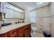 Well-maintained bathroom with vanity, toilet, decorative mirror, and tile backsplash at 479 E Shore Dr # 8, Clearwater, FL 33767