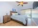 Bright bedroom with a ceiling fan, tile flooring, and balcony access that brings in natural light at 479 E Shore Dr # 8, Clearwater, FL 33767
