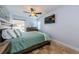 Inviting bedroom with a ceiling fan, dresser, and ample natural light from a bright window at 479 E Shore Dr # 8, Clearwater, FL 33767