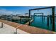 Image showcasing the dock featuring a boat lift for convenient boat storage and easy access to the water at 479 E Shore Dr # 8, Clearwater, FL 33767