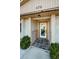 Close-up of a building entrance with a tiled entryway and well-maintained landscaping at 479 E Shore Dr # 8, Clearwater, FL 33767