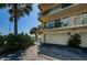 Exterior view of a condo building with garage parking, balconies, and waterfront access at 479 E Shore Dr # 8, Clearwater, FL 33767