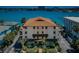 Aerial view of a well-maintained condo building with lush landscaping and waterfront access at 479 E Shore Dr # 8, Clearwater, FL 33767