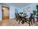 Cozy dining room featuring travertine floors, a modern light fixture, and seating for six at 479 E Shore Dr # 8, Clearwater, FL 33767