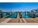 Long wooden dock providing direct access to the water and offering picturesque views of the surrounding harbor at 479 E Shore Dr # 8, Clearwater, FL 33767
