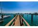 A view down a wooden dock toward a city, with boats on either side at 479 E Shore Dr # 8, Clearwater, FL 33767